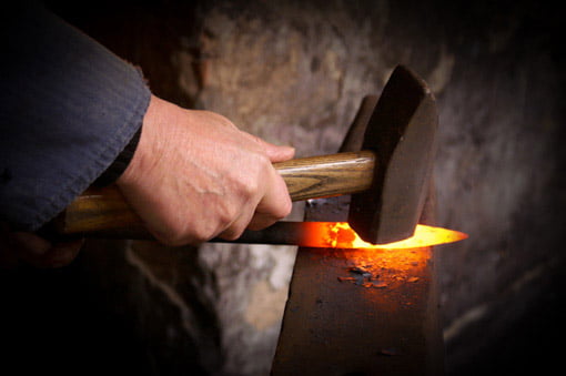 bladesmith-hammering-and-forging-a-knife